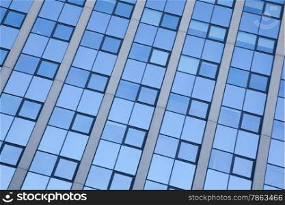 abstract pattern of blue squares on facade of office building