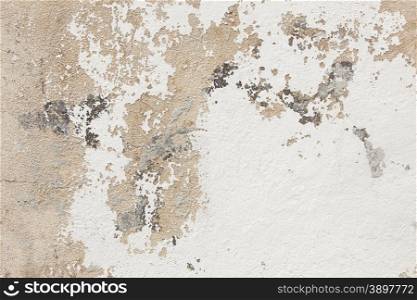 abstract pattern of broken stucco and paint on wall