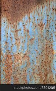 abstract pattern of rusty metal with peeling blue paint