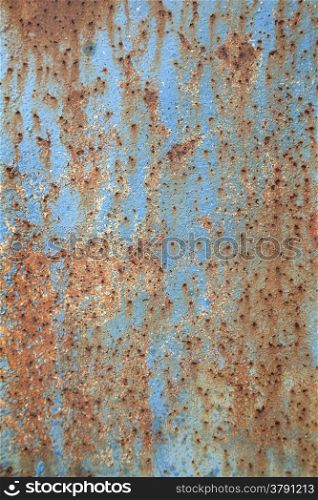 abstract pattern of rusty metal with peeling blue paint