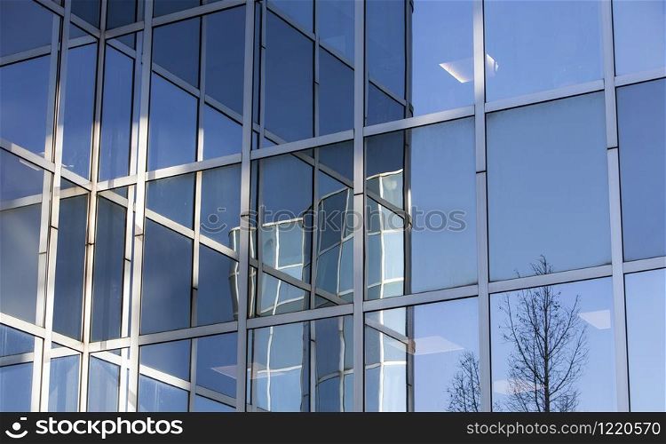 abstract patterns formed by reflections of architecture in windows of modern office buildings