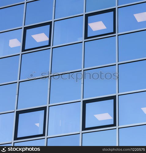 abstract patterns formed by reflections of architecture in windows of modern office buildings