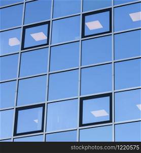 abstract patterns formed by reflections of architecture in windows of modern office buildings