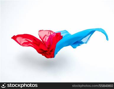 abstract pieces of blue and red fabric flying, studio shot, design element