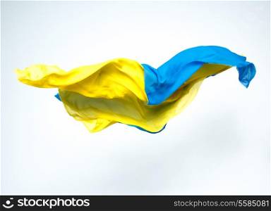 abstract pieces of blue and yellow fabric flying, studio shot, design element
