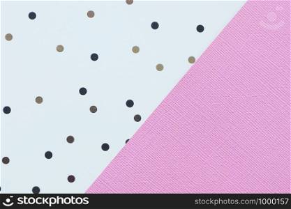 Abstract pink and white paper background with black and brown polka dots.