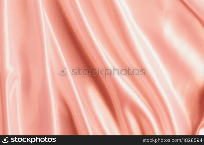 Abstract Rose gold Satin Silky Cloth for background, Fabric Textile Drape with Crease Wavy Folds.with soft waves,waving in the wind.