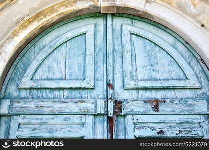 abstract rusty brass brown knocker in a closed wood door carnago varese italy