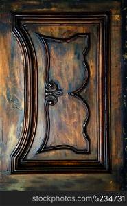 abstract rusty brass brown knocker in a closed wood door lonate ceppino varese italy