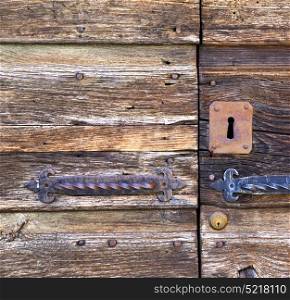 abstract rusty brass brown knocker in a closed wood door mornago varese italy