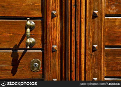 abstract rusty brass brown knocker in a closed wood door olgiate olona varese italy