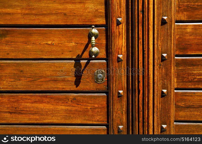 abstract rusty brass brown knocker in a closed wood door olgiate olona varese italy