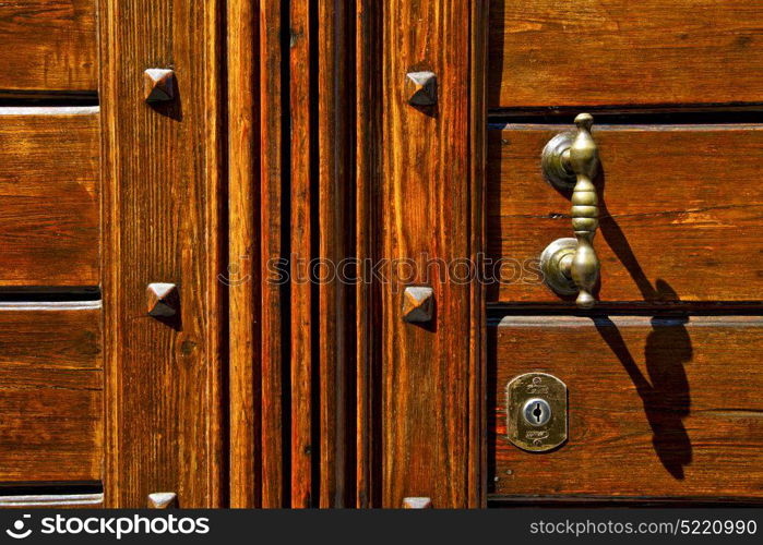 abstract rusty brass brown knocker in a closed wood door olgiate olona varese italy