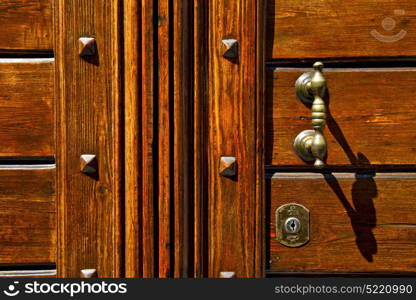 abstract rusty brass brown knocker in a closed wood door olgiate olona varese italy