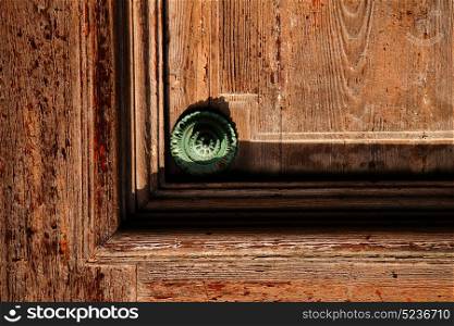 abstract rusty brass brown knocker in a door curch closed wood lombardy italy varese lonate pozzolo