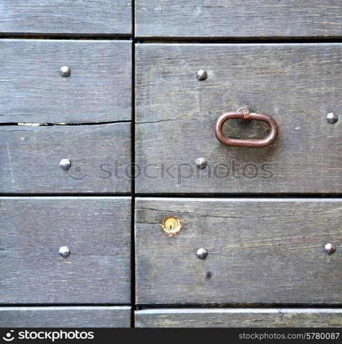 abstract rusty brass brown knocker in a door curch closed wood lombardy italy varese azzate&#xA;