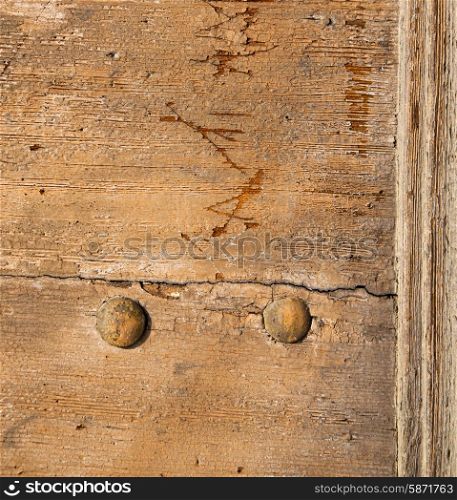 abstract rusty brass brown knocker in a door curch closed wood lombardy italy varese lonate pozzolo&#xA;