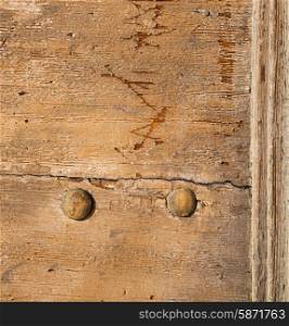 abstract rusty brass brown knocker in a door curch closed wood lombardy italy varese lonate pozzolo&#xA;
