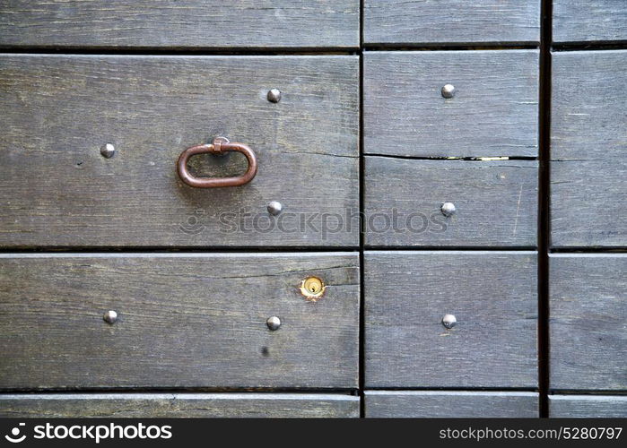 abstract rusty brass brown knocker in a door curch closed wood lombardy italy varese azzate