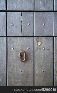 abstract rusty brass brown knocker in a door curch closed wood lombardy italy varese azzate