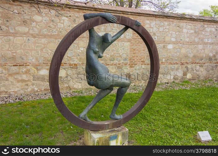 abstract sculpture nude woman inside an iron ring