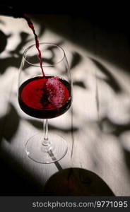 Abstract shadows, sunlight and Glass Of Dry Red Wine