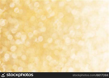 Abstract shining glitters gold holiday bokeh background with copy space for text. Abstract gold background