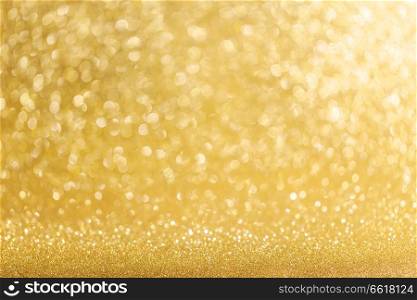 Abstract shining glitters gold holiday bokeh background with copy space for text. Abstract gold background