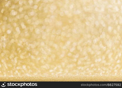 Abstract shining glitters gold holiday bokeh background with copy space for text. Abstract gold background