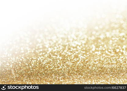 Abstract shining glitters gold holiday bokeh background with copy space for text. Abstract gold background