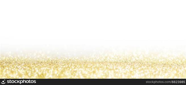 Abstract shining glitters gold holiday bokeh background with white copy space. Abstract gold background