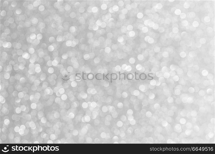 Abstract shining glitters silver holiday bokeh background with copy space for text. Abstract silver background