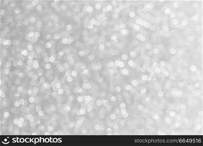 Abstract shining glitters silver holiday bokeh background with copy space for text. Abstract silver background