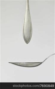Abstract Silver Dessert Spoon Cutlery and spoon like drops fall