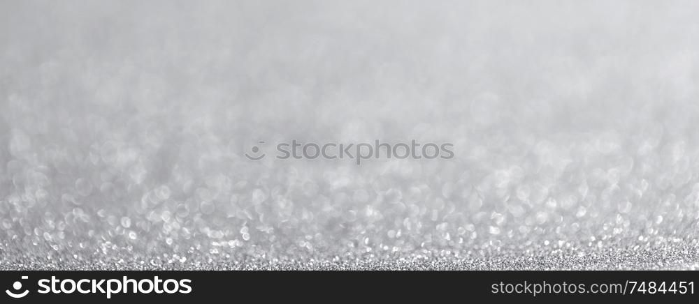 Abstract silver glitter light bokeh holiday party background. Abstract silver glitter background