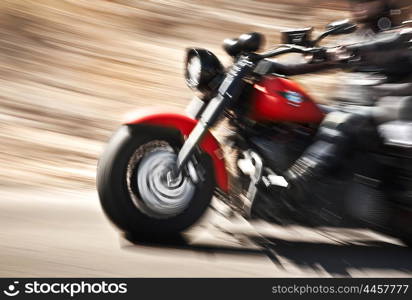 Abstract slow motion, biker riding motorbike, driver racing on the big red bike, side view, blur movement, summer road trip, speed concept