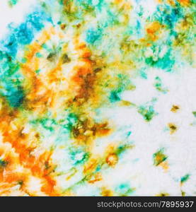 abstract stains of batik painted on white silk close up