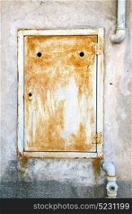 abstract steel padock zip in a closed rusty metal pattern door varese italy sumirago