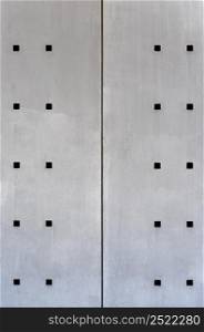 abstract steel wall with square holes front view