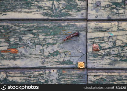 abstract sumirago cross brass brown knocker in a closed wood door varese italy sunny day