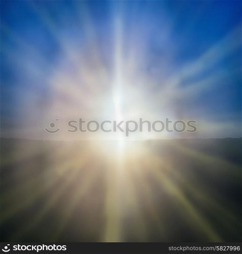 Abstract sunset- shining sun with sunbeams on the blue sky background
