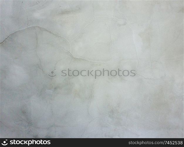 Abstract surface off smooth, grey plaster wall with cracks and scratches. Old grungy, weathered construction structure, dirty texture.