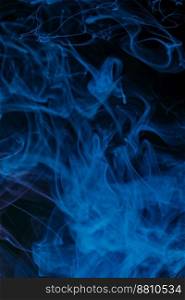 Abstract swirling smoke texture on black background.