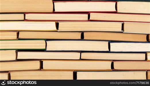 abstract texture from stacks of various hardback books, full frame, concept back to school