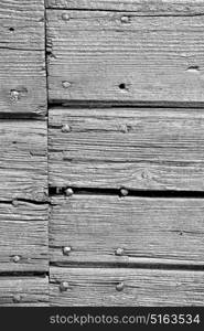 abstract texture of a brown antique wooden old door in italy europe