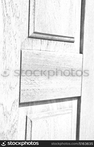 abstract texture of a brown antique wooden old door in italy europe