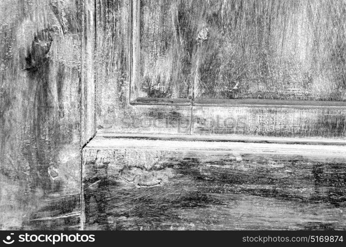 abstract texture of a brown antique wooden old door in italy europe