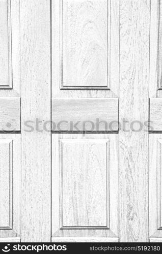 abstract texture of a brown antique wooden old door in italy europe