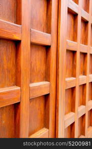 abstract texture of a brown antique wooden old door in italy europe