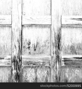 abstract texture of a brown antique wooden old door in italy europe